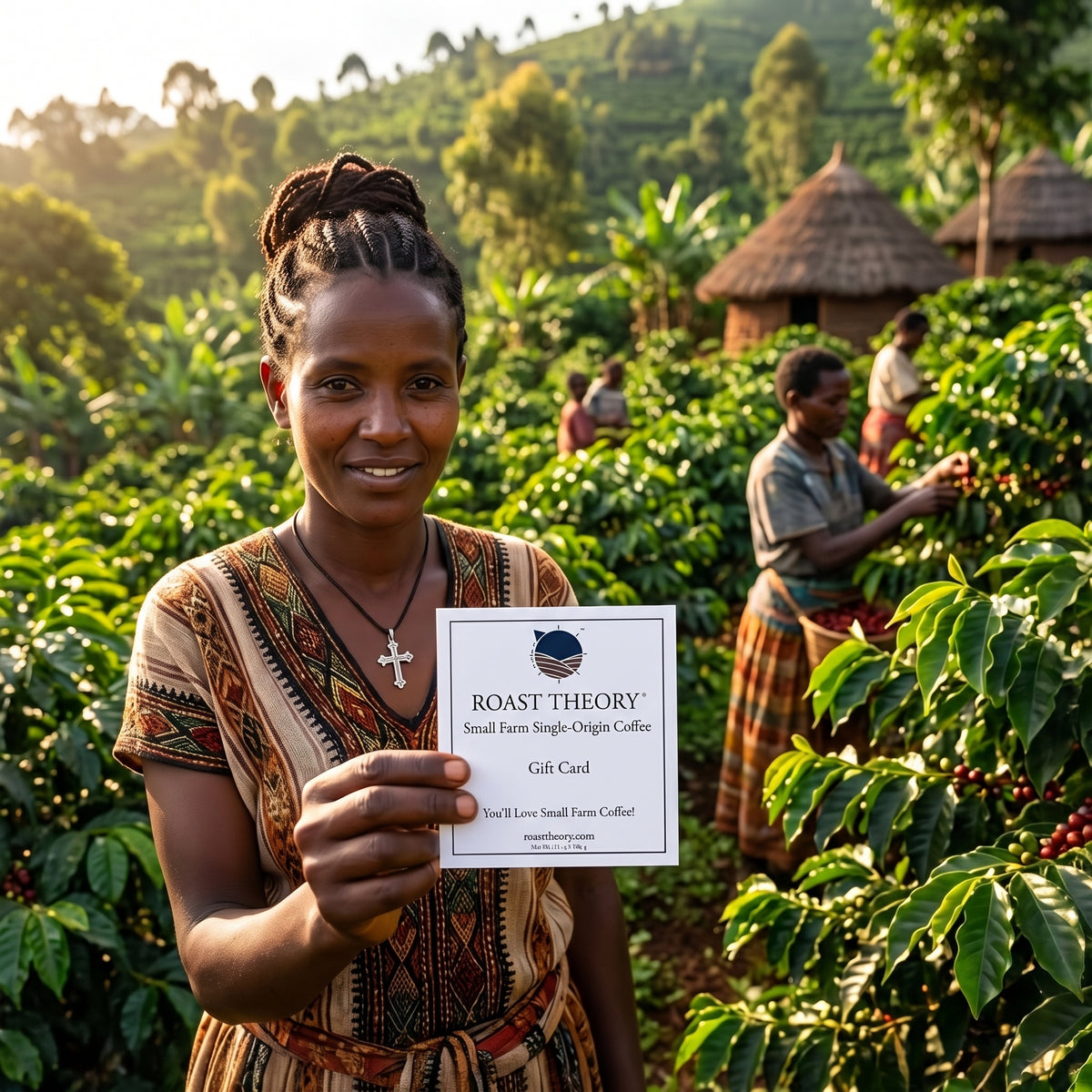 A woman in a coffee farm stands smiling and holding a gift card that reads 'ROAST THEORY Small Farm Single-Origin Coffee Gift Card' in front of a lush green coffee plantation with other workers and thatched huts in the background.
