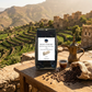 Yemen Harazi Mocha Jibal Raymah Coffee by Roast Theory with a scenic background of Yemen mountains and buildings.